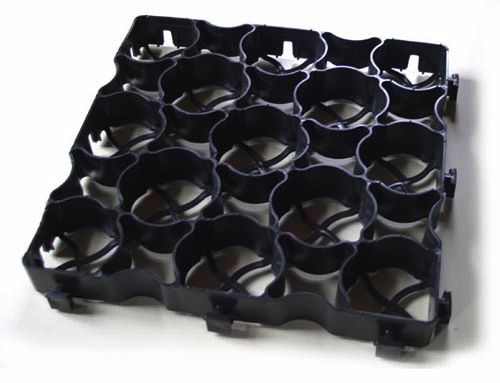A recycled plastic ground reinforcement grid for drain thorough hardstanding